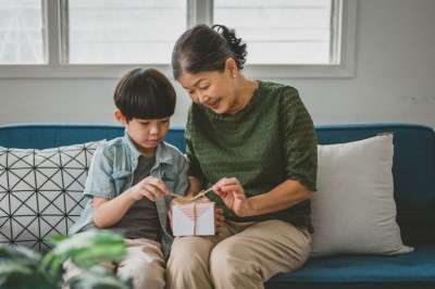 boy giving gift grandmother gift cards