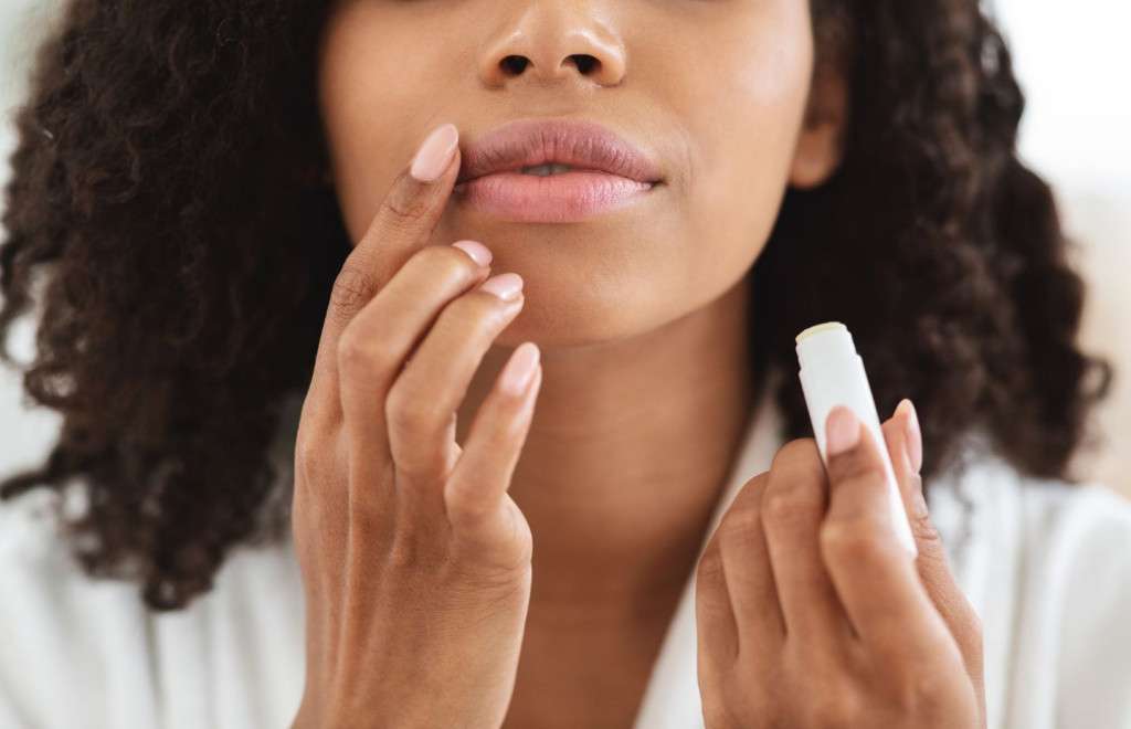 woman applying lip balm